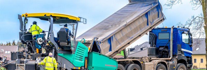 machine asphalting of roads. truck with asphalt. the creation of a new transport communication and infrastructure. High quality photo